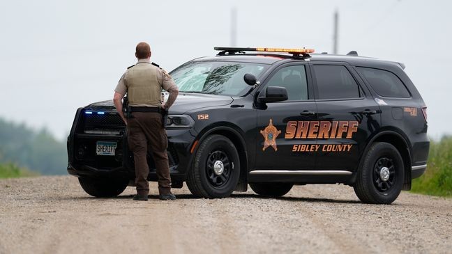 A Sibley County Sheriff's Deputy blocks the road where the suspect involved in the shooting of two state lawmakers vehicle was found Sunday, June 15, 2025, in Faxon Township, Minn. (AP Photo/George Walker IV)