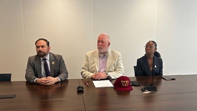 The photo shows a news conference with D.C. Department of Buildings. (7News)