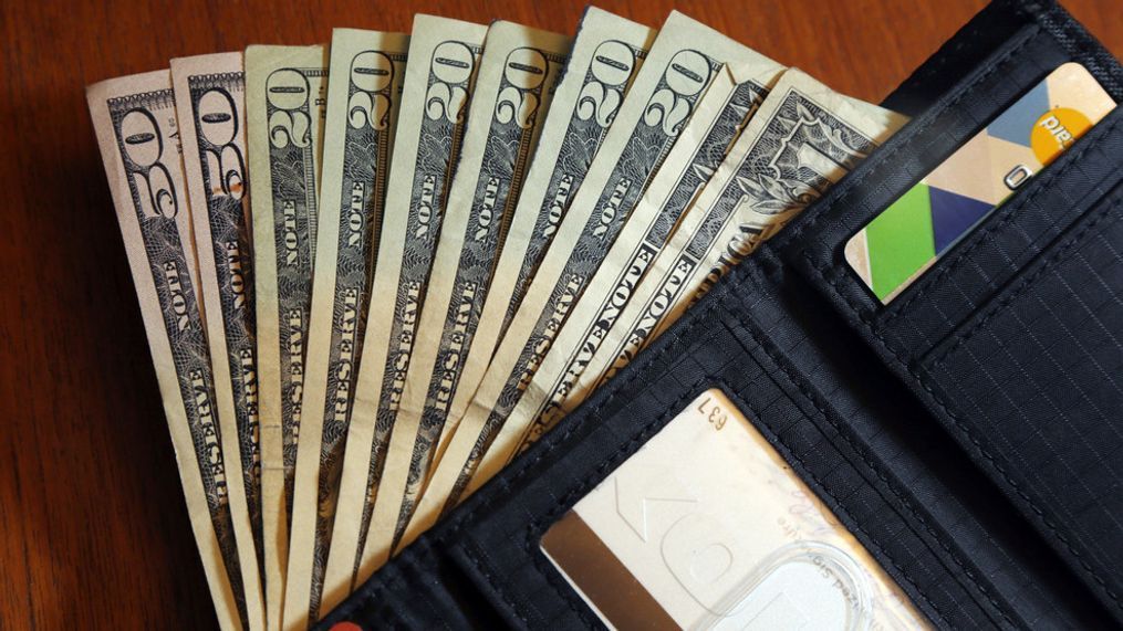 FILE - In this June 15, 2018, file photo, cash is fanned out from a wallet in North Andover, Mass. (AP Photo/Elise Amendola, File)