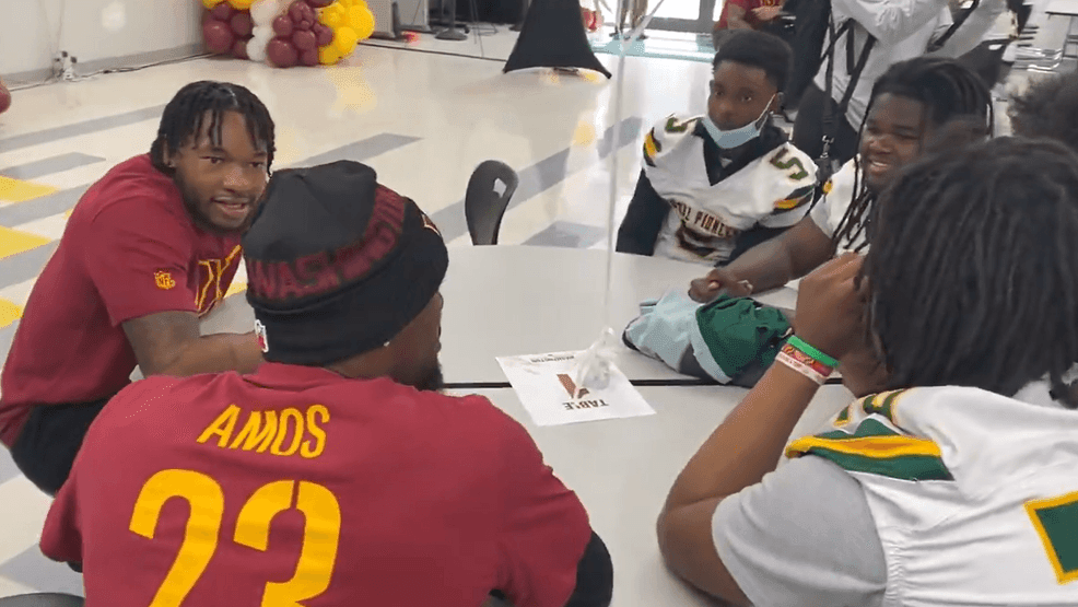 Image for story: Commanders rookie class visits high school students in Southeast DC